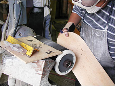 board being sanded by hand